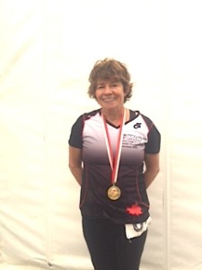 Vi Woods wearing a gold medal for winning a dragon boat race